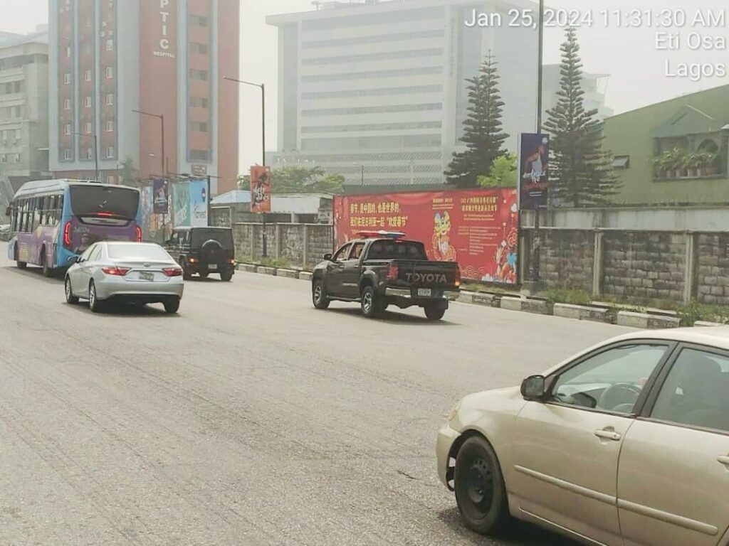 Images showing Chinese celebration billboard and cars.