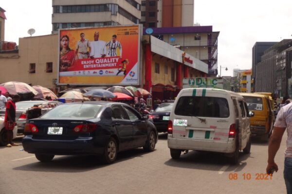 Wall Drape Billboard mounted on a buildinf and capturing attention in the streets of Lagos