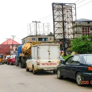 High-visibility portrait billboard in Onitsha, capturing the bustling city traffic.