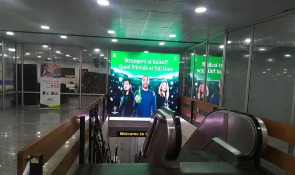 LED Billboard at Murtala Muhammed International Airport in Lagos, displaying an engaging advertisement near escalators for maximum traveler visibility.